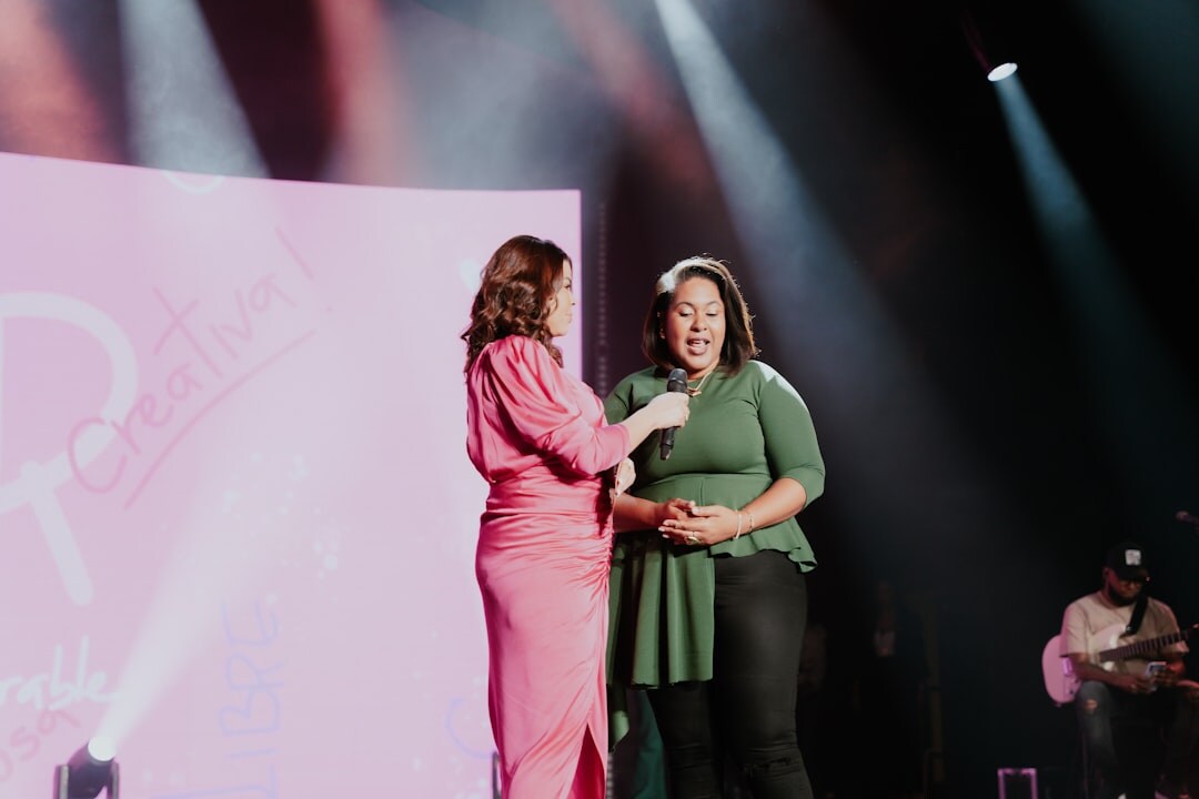 Person receiving an award on stage during a conference awards ceremony