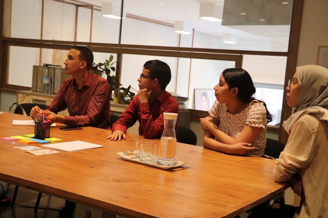 Business forum with panelists seated at a table discussing in front of an audience