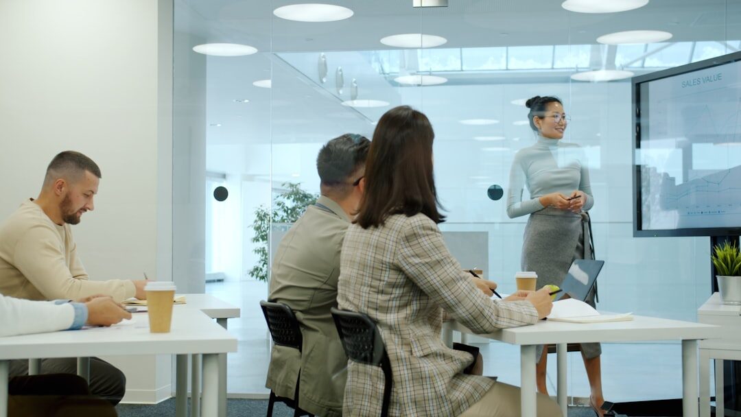 Trainer presenting to a seated group of professionals during a workshop session
